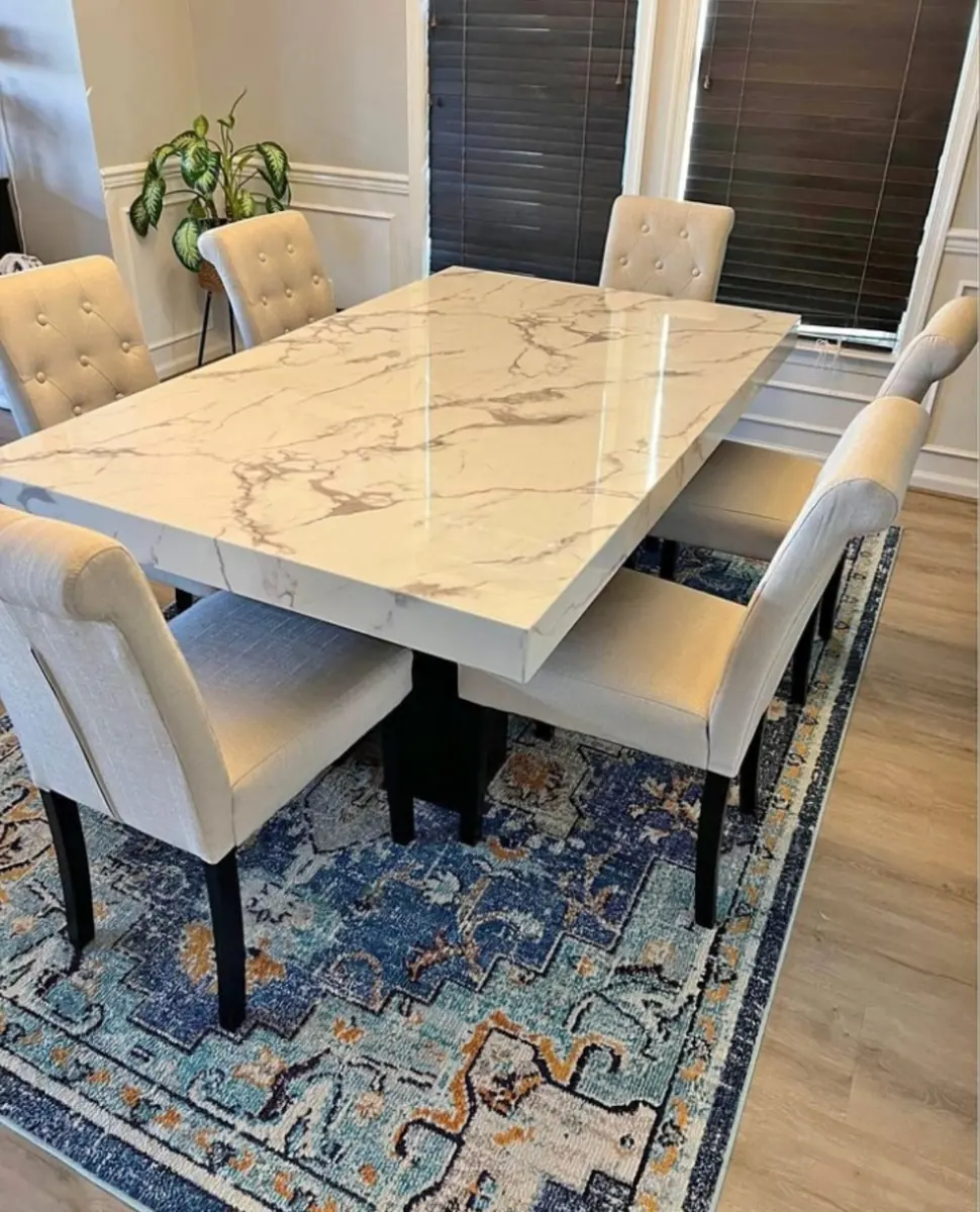 Marble dining table with upholstered chairs by Kabom Furniture