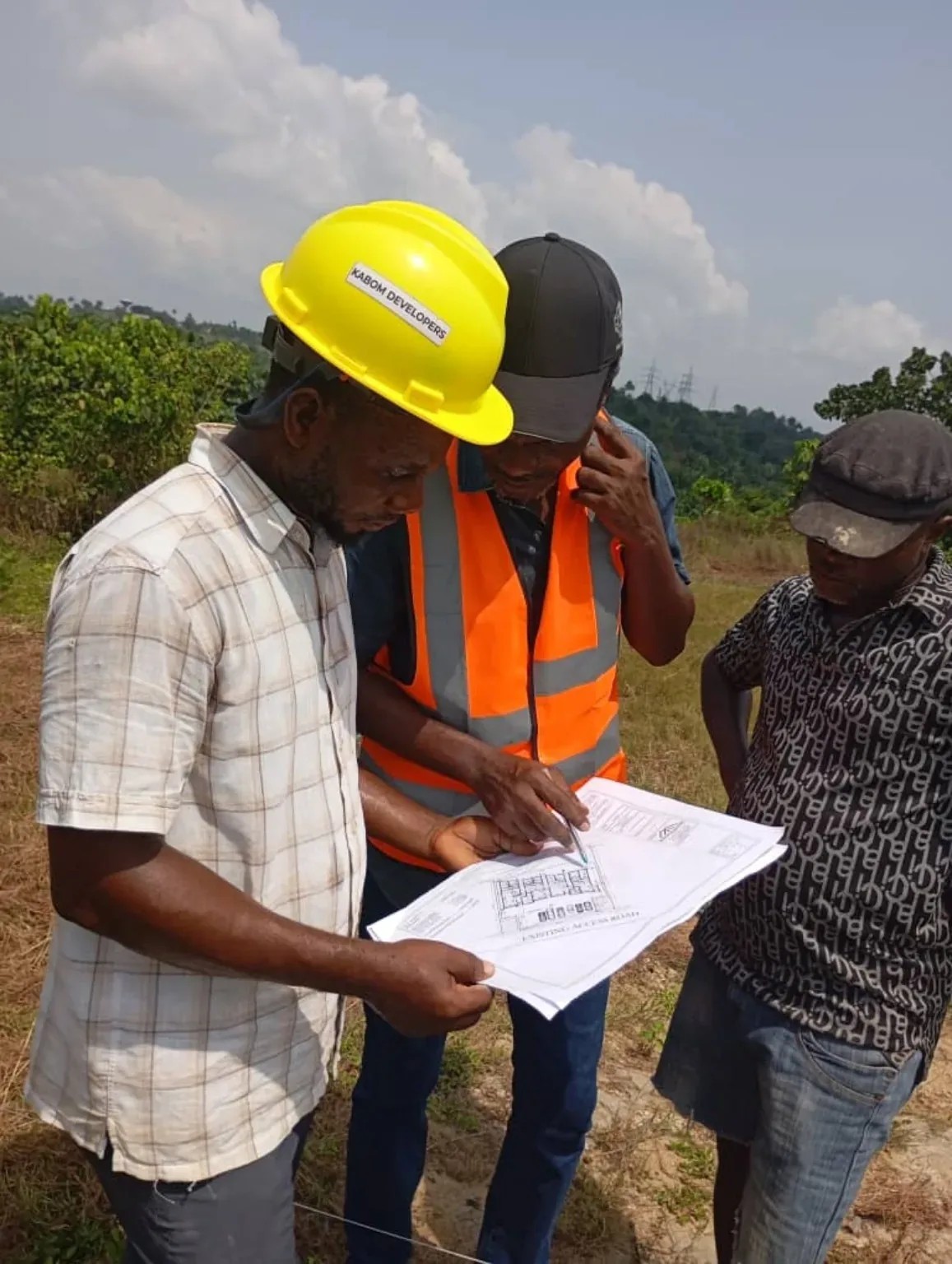Kabom Developers team reviewing development plans on site